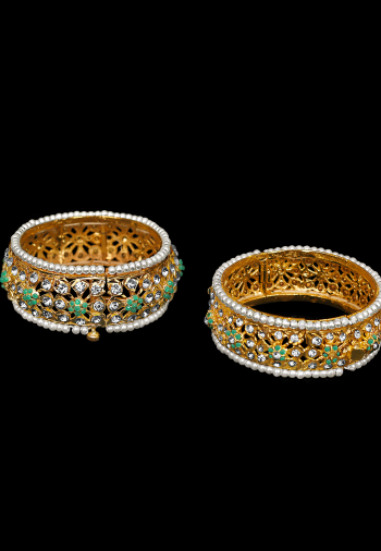 Gold bangle with kundan. Openable. Green, multicolor and red.